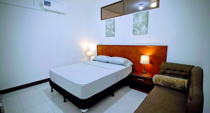 ✅️ Spacious room.
✅️ Queen bed
✅️ Sofa
✅️ Bedside tables and lamps at night.
❄️ Air con
 ✔️Store clothes.
