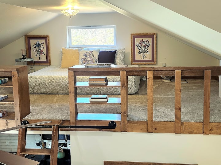 Tucked away upstairs, this second-story loft features a queen-size bed layered with soft, comfy blankets and plush pillows. Gaze out over the lake from your elevated perch and enjoy a quiet moment surrounded by nature.