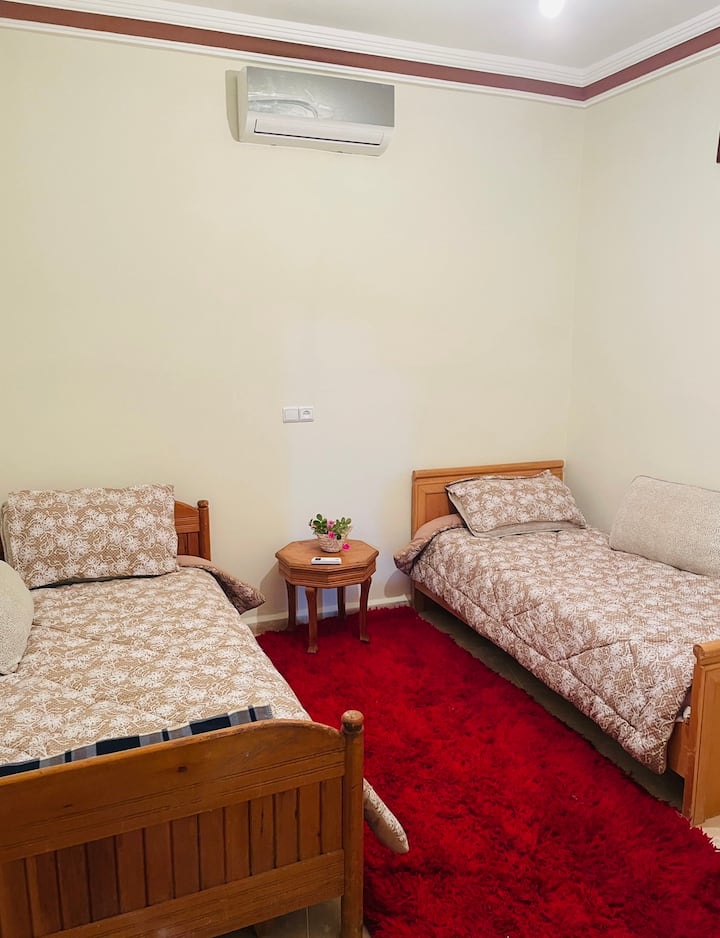 Indulge in comfort in our bedroom with two beds and air conditioning. Perfect for a restful night's sleep after exploring Chefchaouen. Book now for a cozy retreat