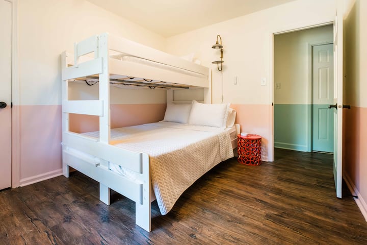 bright bedroom with twin-over-queen bunkbed