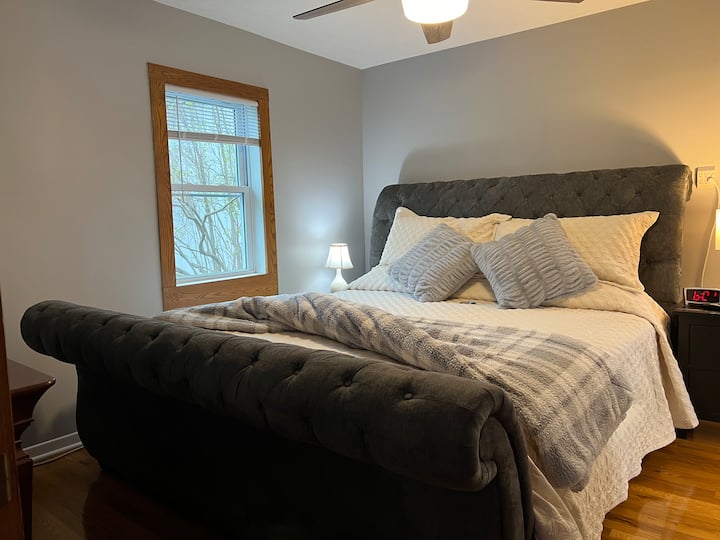 Master Bedroom (King) with private bath and smart TV.