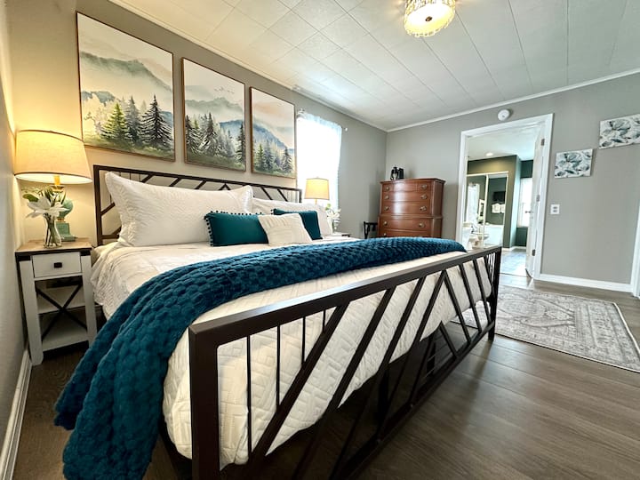 Primary bedroom features a king bed with a mountain inspired headboard and footboard. A large private bathroom is connected to the primary bedroom for all your privacy needs. 