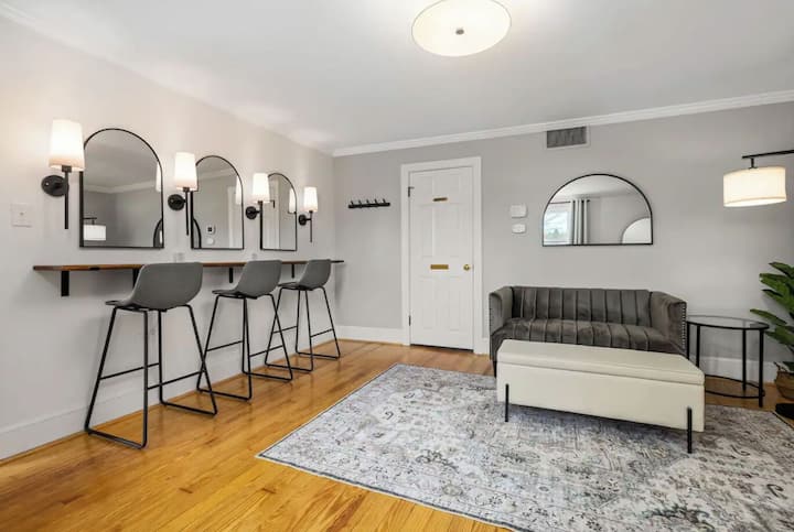 The getting ready room (also Bedroom #1) includes a beauty bar for hair and makeup, small loveseat, full bathroom, oversized mirror, and a pull down queen murphy bed.