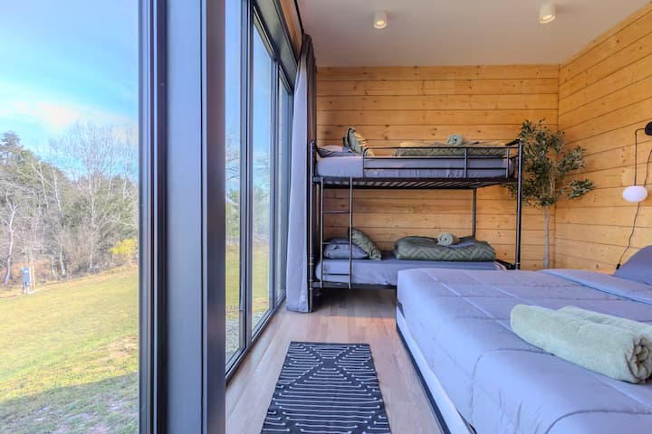 Spacious room with a king bed, bunk beds, and scenic views.