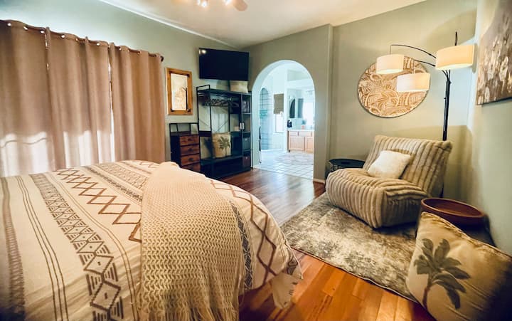 Amplia suite principal con cama king, TV Roku de 52pulgadas, sala de estar con sillón reclinable extra grande y lujoso, que conduce al gran baño principal con ducha escalonada y acceso al patio trasero.