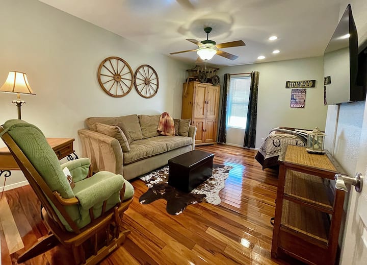 Dormitorio de invitados con sala de estar y cama tamaño queen