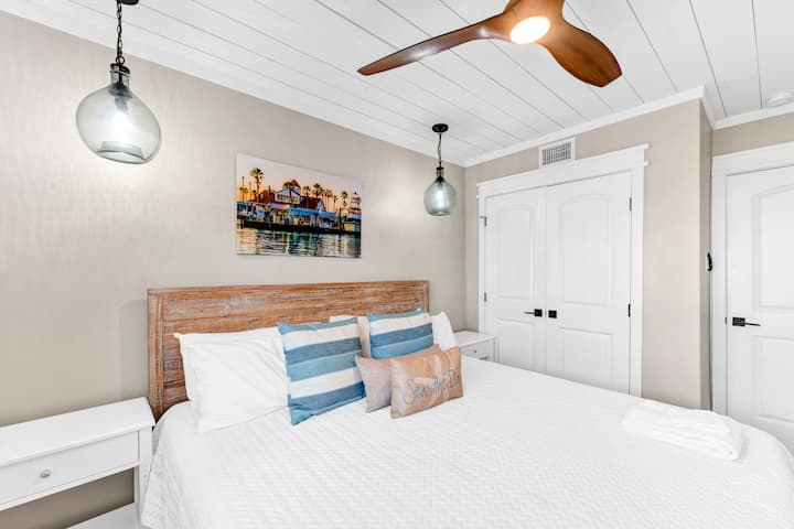 Rest peacefully in your coastal-inspired bedroom featuring crisp linens, warm wood accents, and charming nautical touches that make every night feel like a seaside escape.