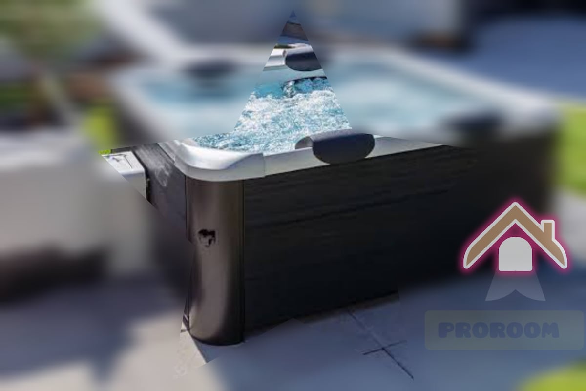 A hot tub is positioned outdoors, featuring bubbling water and a contemporary design. Surrounding the hot tub are smooth, light tiles and greenery, creating a relaxing outdoor atmosphere suitable for leisure and comfort.