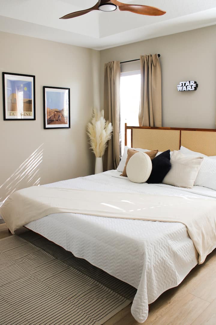 Step into the Star Wars Boho Bliss Room, inspired by desert planets like Tatooine! Relax in a cozy king bed with earthy tones, rattan accents, and space-inspired décor. Enjoy a Smart TV, WiFi, and a galactic retreat, just minutes from Disney!