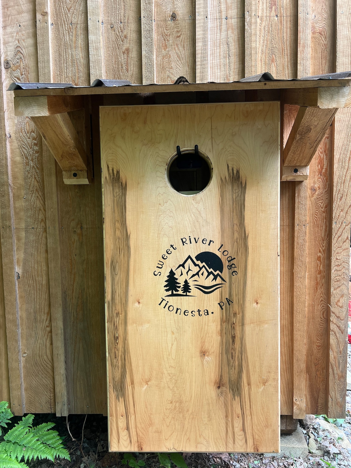 Play a game of Corn Hole provided by Sweet River Lodge! Bags are hanging behind the boards at Sweet River Lodge in Tionesta
