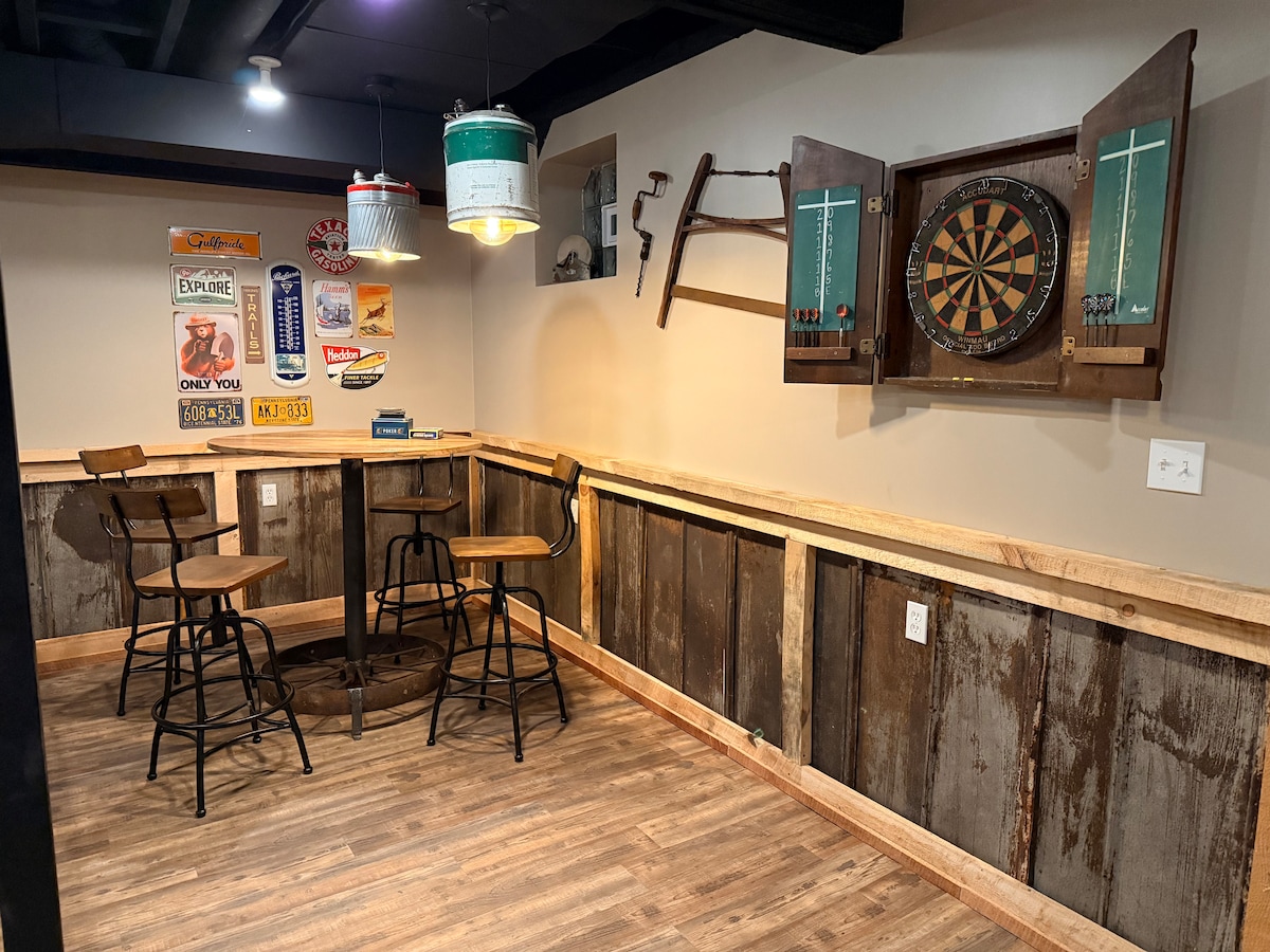 Dart board and pub style table with seating for four. at Sweet River Lodge in Tionesta