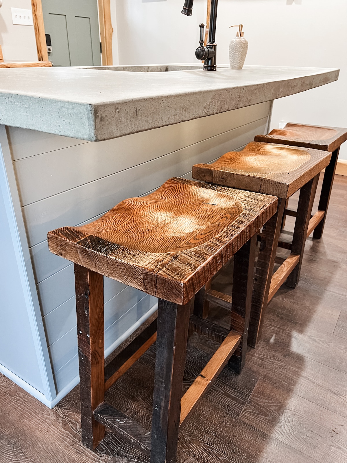 Reclaimed custom built bar stools from an early 1900's Cleveland house at Sweet River Lodge in Tionesta