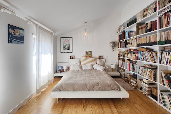 Tintin Suite with king-size bed, comic library collection, artwork, and a stunning farm view resembling a small historic village within a historic farmland estate