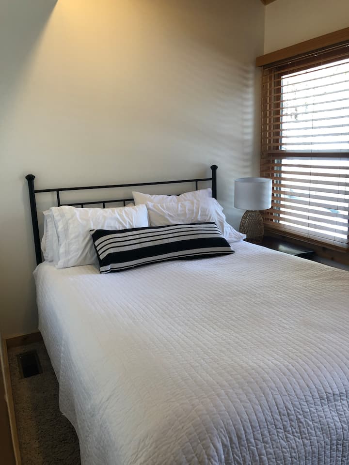 Main bedroom on first floor has a queen sized bed.
