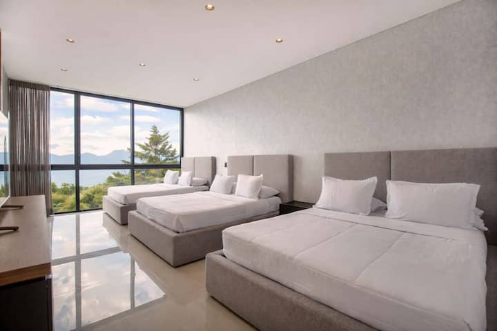 Two luxurious beds with hotel-quality linens await in this perfectly symmetrical setup—ideal for sharing without sacrificing comfort or privacy.