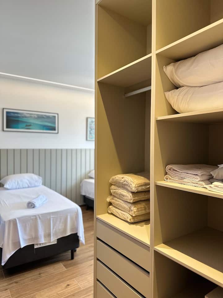 Single Suite, with two castor single beds 88cm, with auxiliaries below. 