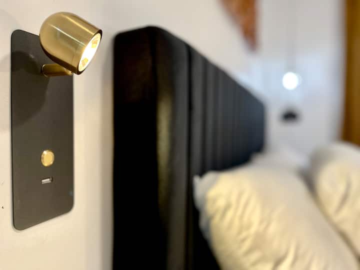 Modern touches meet soft comfort. Perfect lighting for your nighttime unwind.