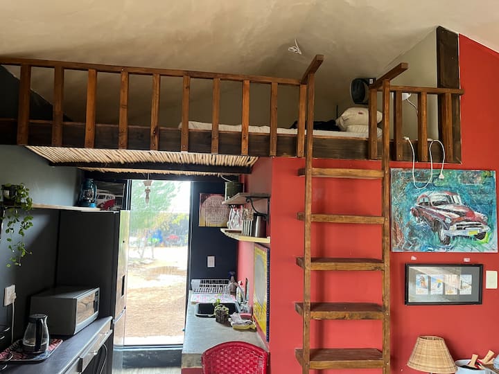 The mezzanine level in the bunkhouse with a queen madrac 