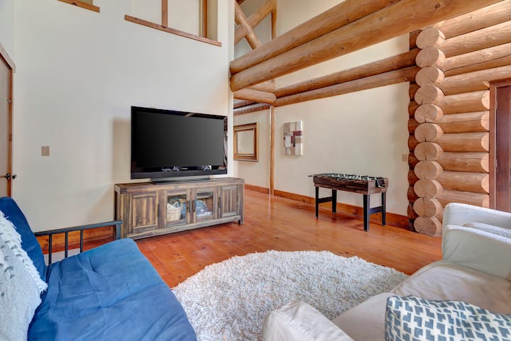Additional living space with entertainment center—flat-screen TV, comfortable seating, and rustic wood media console