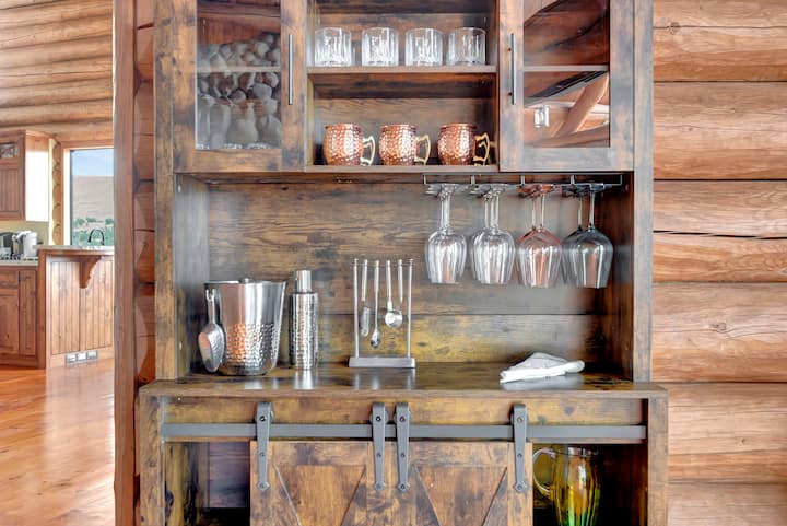 Custom rustic bar with barn door accents—fully stocked with glassware, barware, and everything you need for entertaining.