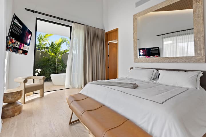 1st Master Suite- king bed/ Smart TV / Reading corner / Walk-in closet / Outdoor Showers & Bathtub.