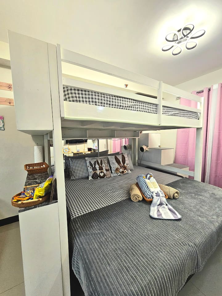 King size bed and full size loft bed with extra pillows, and fleece blanket 