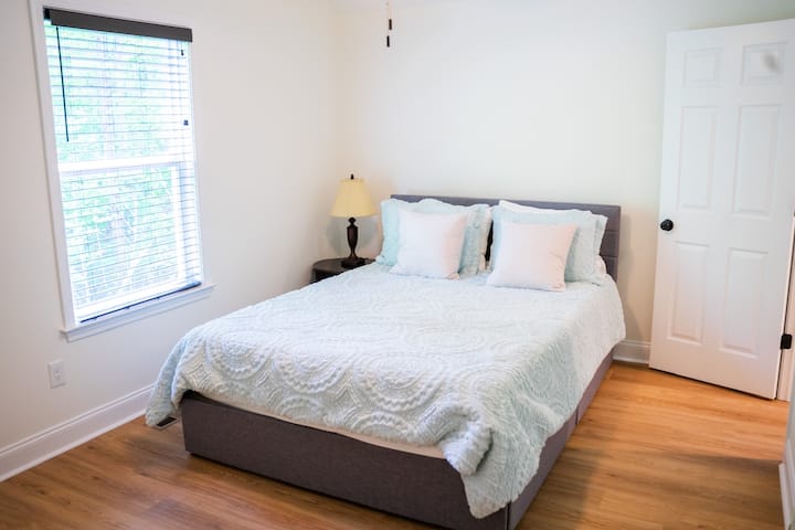Experience comfort in our welcoming third bedroom in Dahlonega. Relax on the queen bed and enjoy the cozy ambiance. Your peaceful retreat awaits – reserve your stay today!
