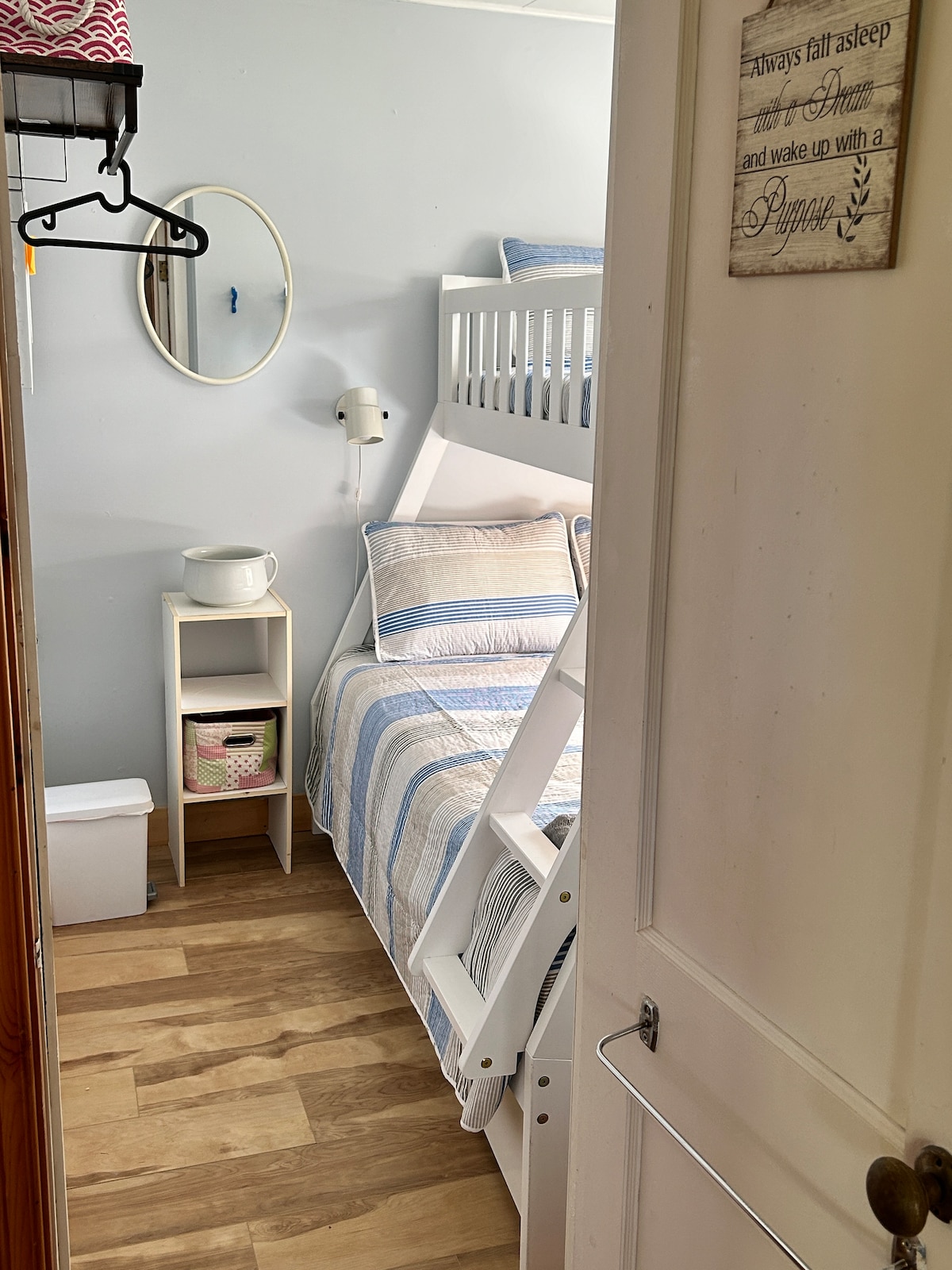 This cozy space features bunk beds with a double bed and twin on top. 