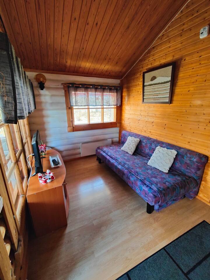 The living room has a 32 inch TV and a sofa bed that can be expanded as a 140cm sleeping space for two people
