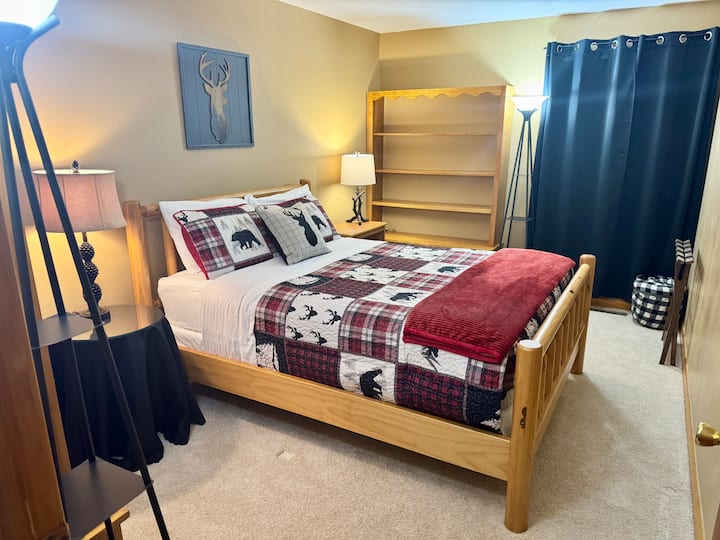 This spacious bedroom offers accommodations for up to two guests with a QUEEN sized bed! Large shelf cabinets at each end of room provide lots of storage space. Table and floor lamps are used for room lighting.