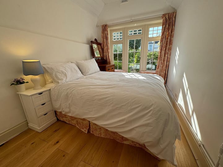 Bedroom 3 is lovely with its matching valance, curtains and window seat cushions.  There is also access to the rear garden.