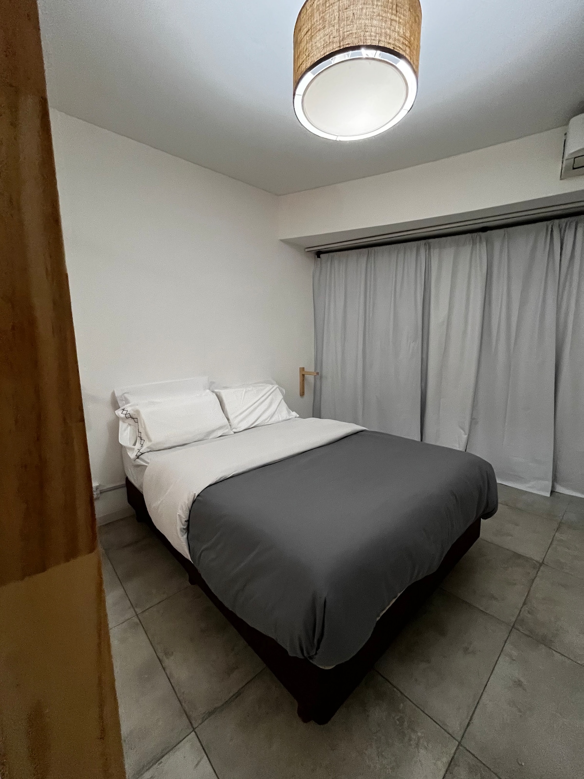 This is the strongest interior unit photo available. It clearly shows a bedroom inside the apartment, feels bright and presentable, and gives travelers a straightforward sense of the accommodation. The rooftop amenity shots are less useful,