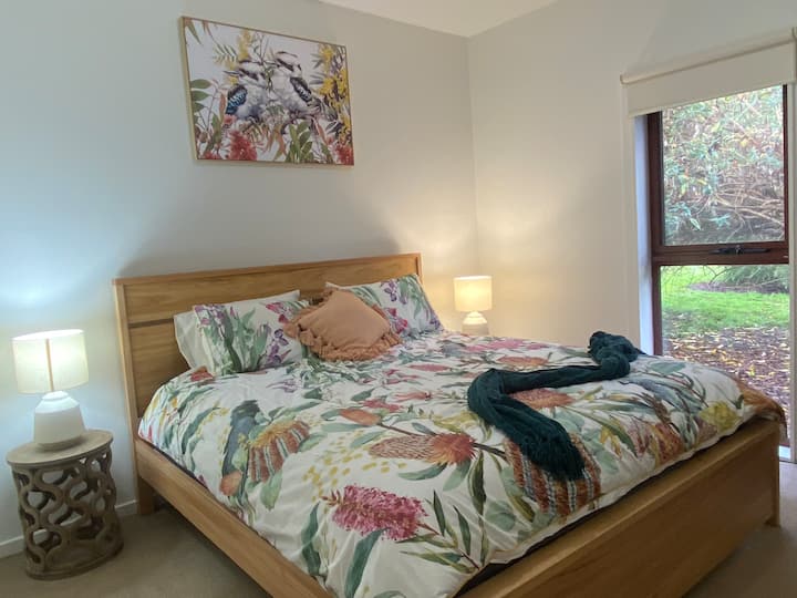This bedroom is located downstairs off the main living area. It is a spacious room with a side window view of the property. It is located off from the main loungeroom and captures the warmth of the fireplace effectively.