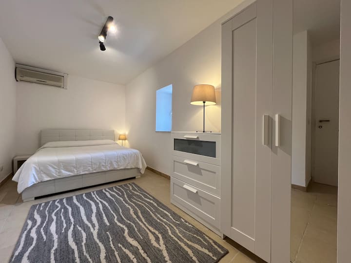 The master bedroom offers a king size bed with bed-side tables, a chest-of-draws, and a wardrobe with hanging space, shelves, and full length mirror. A new air-conditioning unit has been installed August 2024.