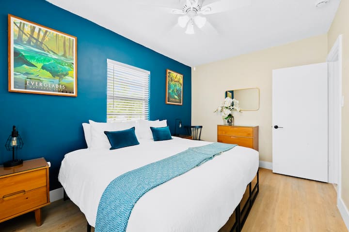 A peaceful bedroom inspired by Everglades National Park, offering a king bed or two twins. Solid wood bedside tables, a dresser, USB bedside lamps, a chair, & mirrors create a comfortable, well-appointed retreat rooted in nature.