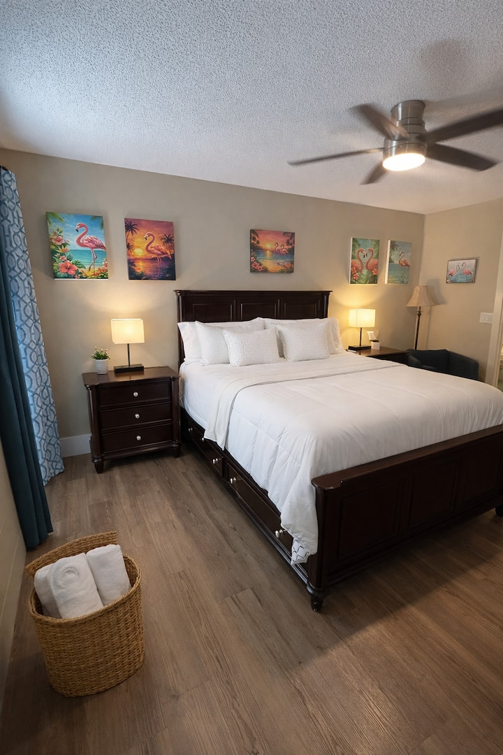 Primary bedroom with comfortable bed, soft lighting, and coastal touches designed to help you unwind and recharge during your stay