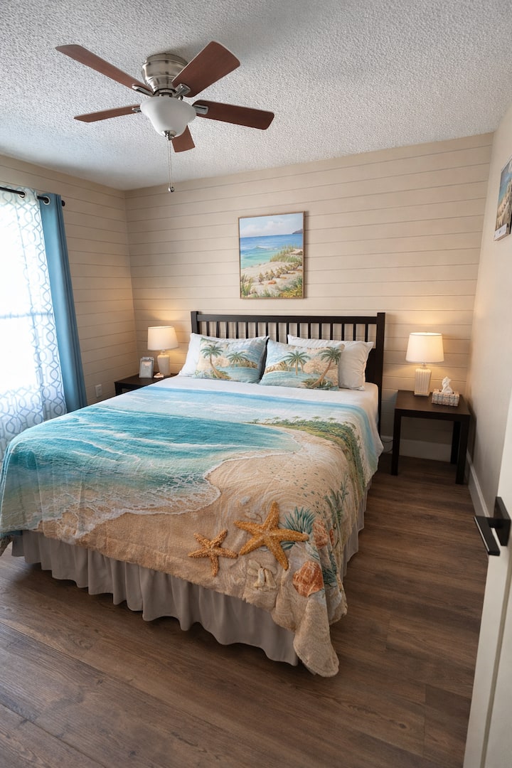 Beach themed bedroom designed with relaxing coastal colors and comfortable bedding for a peaceful night’s sleep.