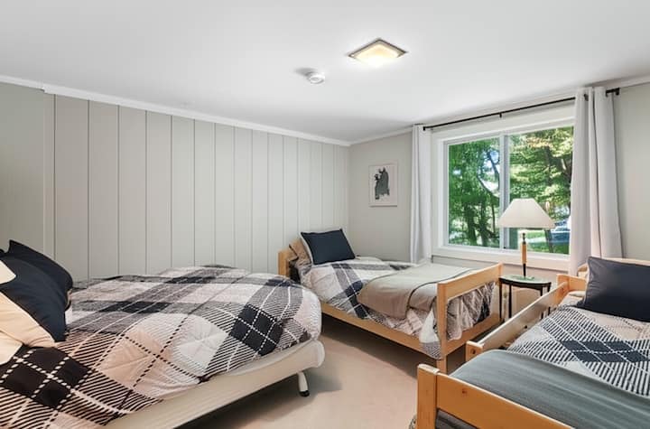 Bedroom with full bed and 2 single beds. Perfect for kids! This room also has blackout shades and we can provide a pack-n-play upon request