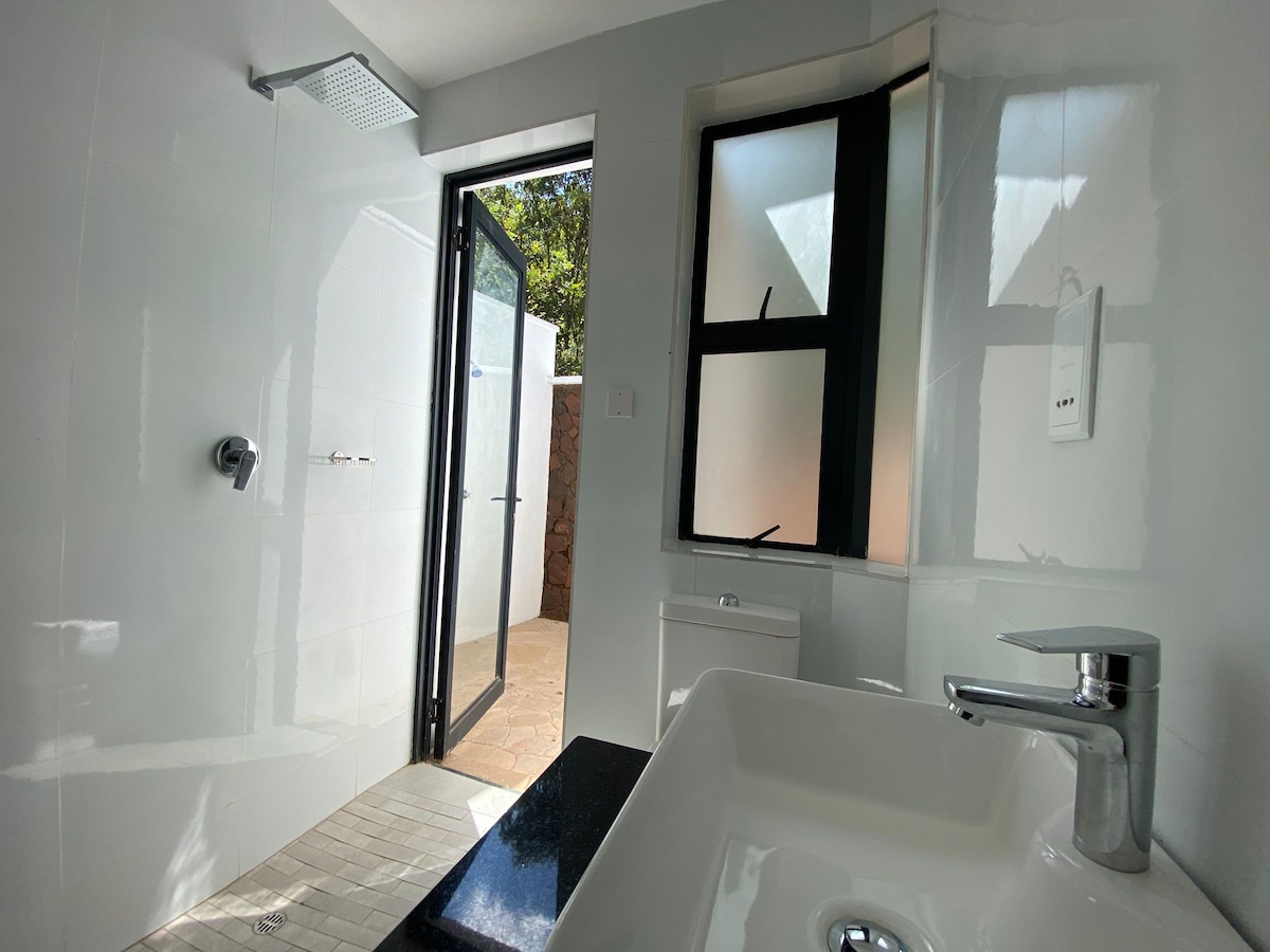 Private outdoor rain shower with views — The Treetop Penthouse, Shawasha Hills Harare