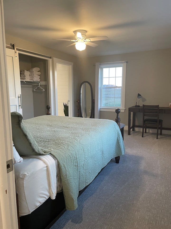 The entrance to bathroom one is to the right of the closet. 