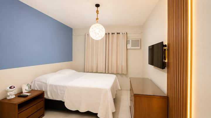 Bedroom with 1 double bed and 1 single bed with a dresser.