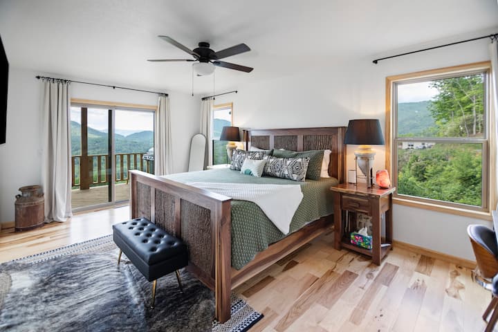 Imagine waking up together in this serene bedroom, surrounded by mountain views through large windows. Step out onto the private deck to enjoy your morning coffee, soaking in the peaceful atmosphere. It’s the perfect spot for a romantic escape.