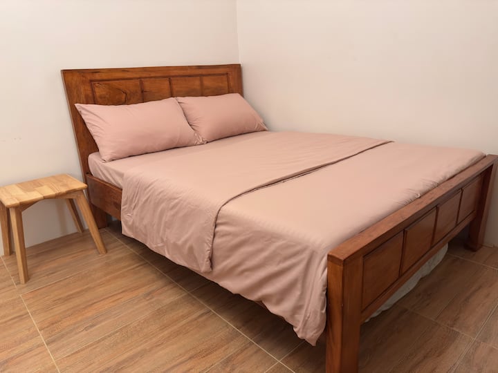 Full-size bed accommodates 2 guests. A floor mattress (stored under the bed) is provided for the 3rd guest, and the comfy sofa can be used as a bed for the 4th.