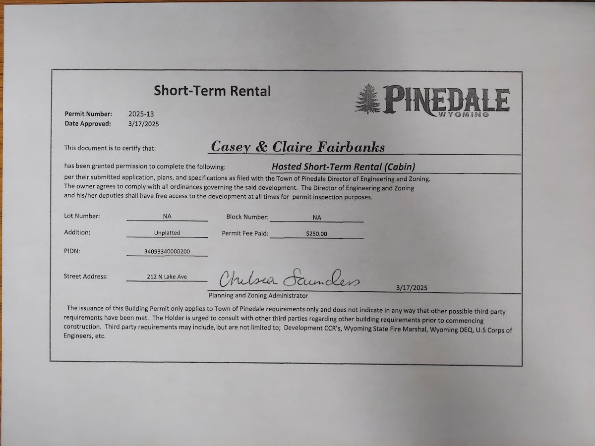 A formal document displaying the short-term rental permit for a cabin. The permit includes the names of the owners, the permit number, and approval date details, providing essential information for compliance with local regulations.