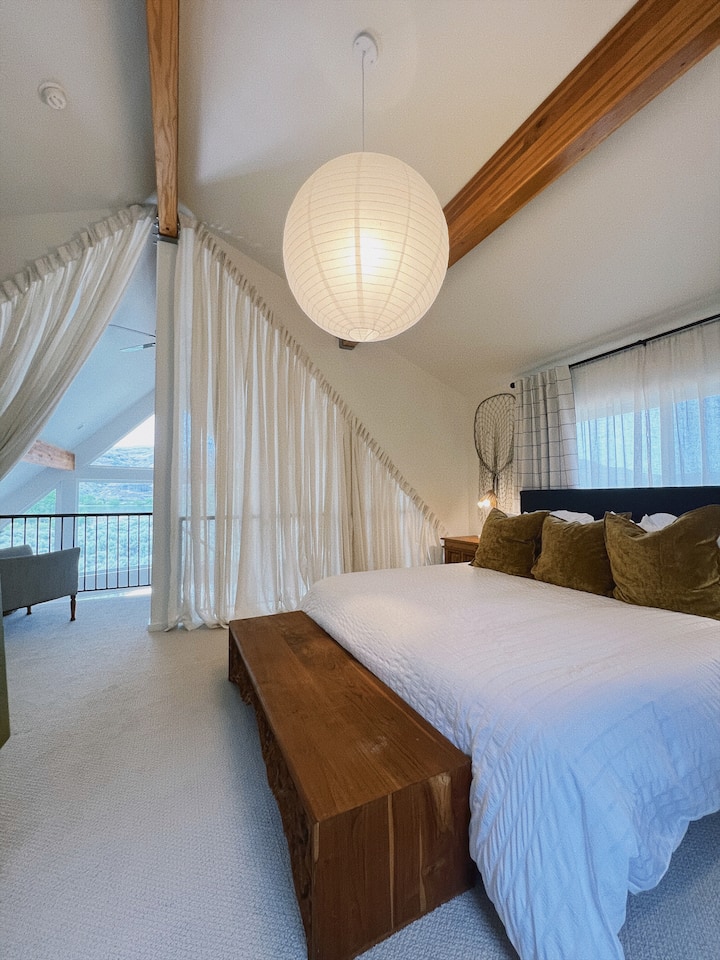 Loft style Master Bedroom with curtains for privacy. 
