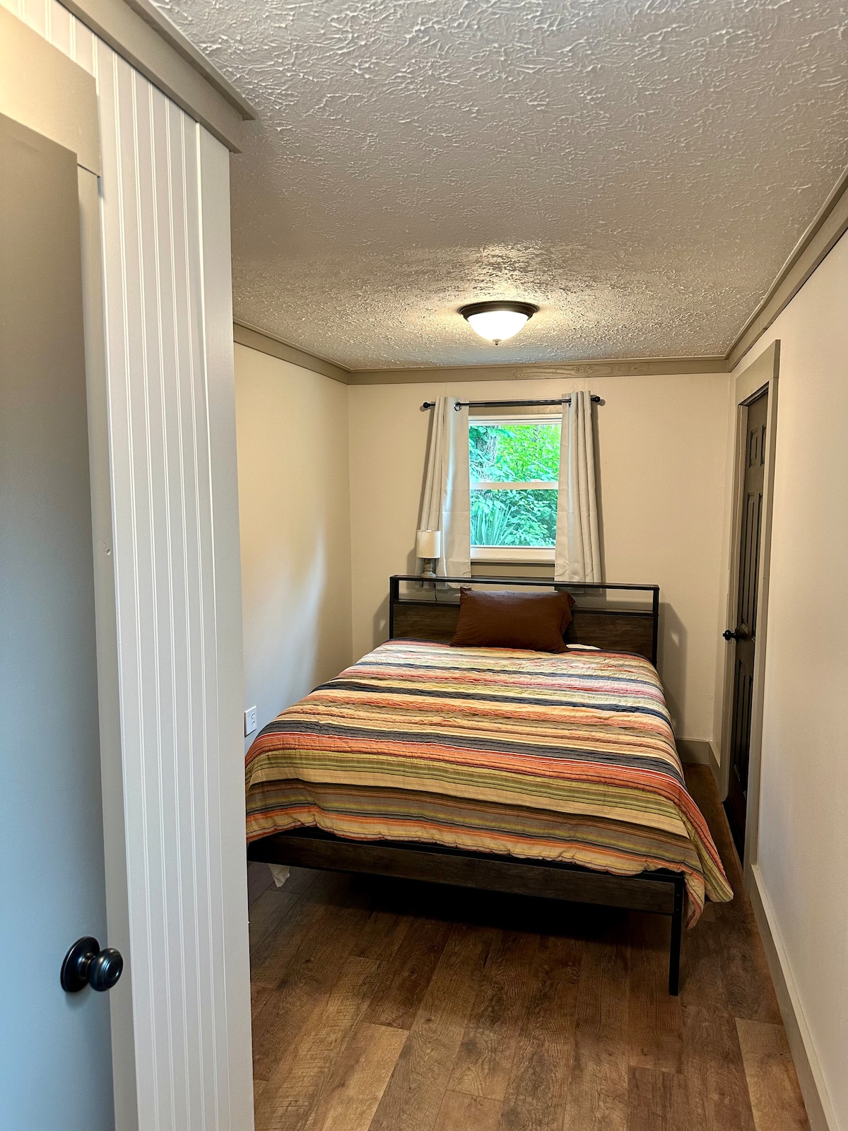 Spálňa na prízemí vedľa práčovne. Má veľkú skriňu, nový matrac s pamäťovou penou a rám postele so vstavanými nabíjacími portmi. 