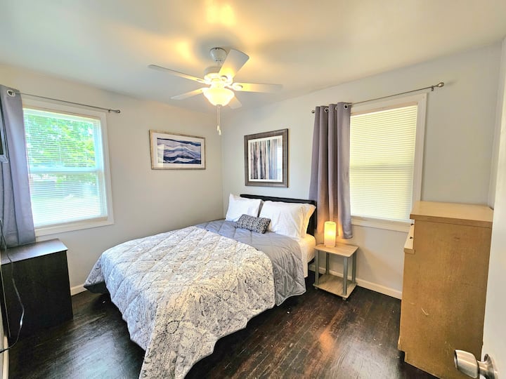 Lujosa cama tamaño queen y ropa de cama con cortinas opacas