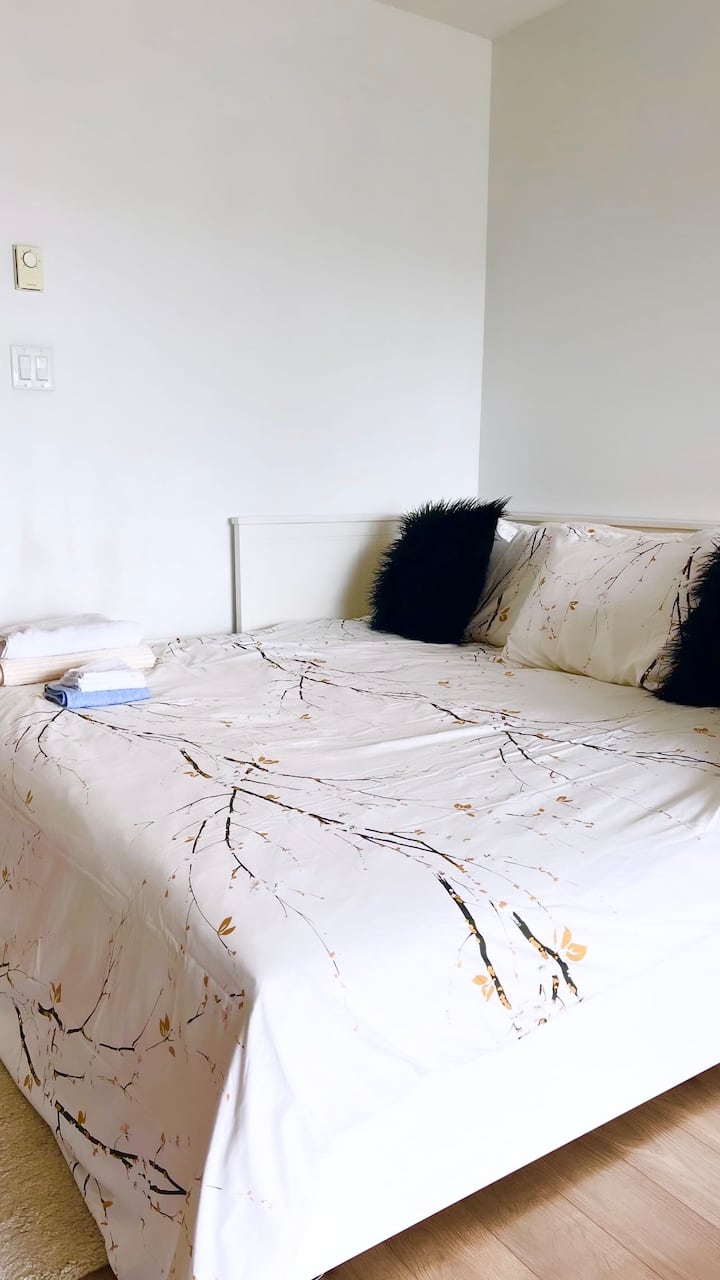 Lo spazio della camera da letto dispone di ampie finestre per permetterti di goderti la vista sullo skyline mentre ti rilassi in un comodo letto a due piazze, con lenzuola bianche e coperte extra. 