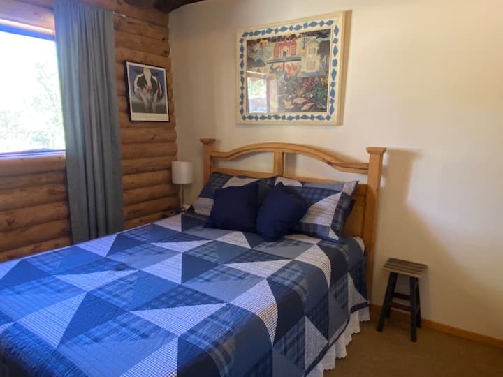 Bedroom #2 with queen bed and comfortable cotton quilt.  Lamp with charging station 