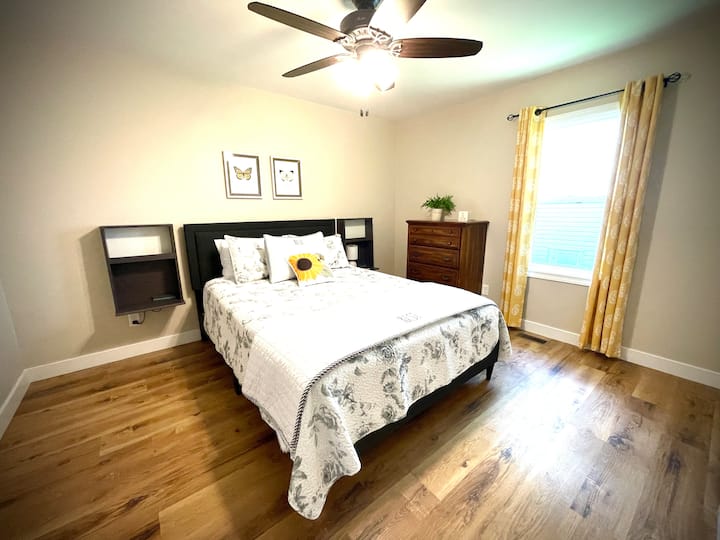 Queen bedroom with brand new mattress, ceiling, fan, and a closet for storage! 